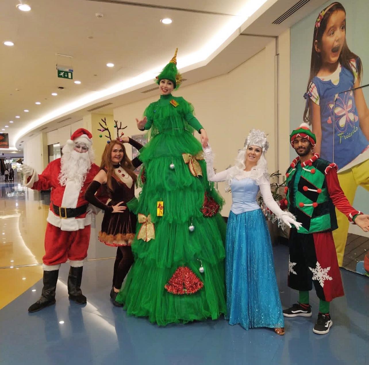 Christmas Parade with XMAS tree stilt walker