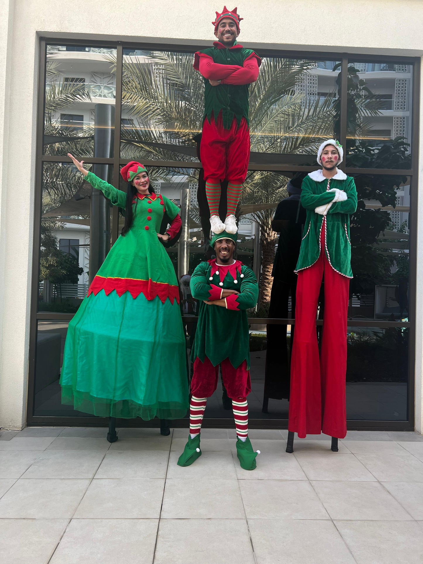 Christmas parade with female and male stilt walker