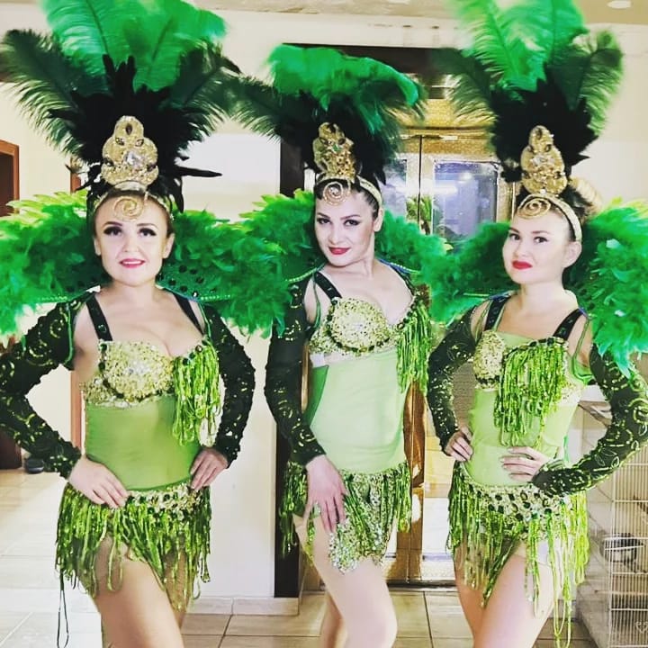 Green Feather Dancers and Hostess by Fidelio Arts