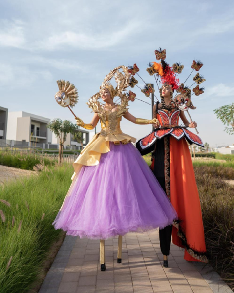 Purple and Red Masquerade Stilt Walkers