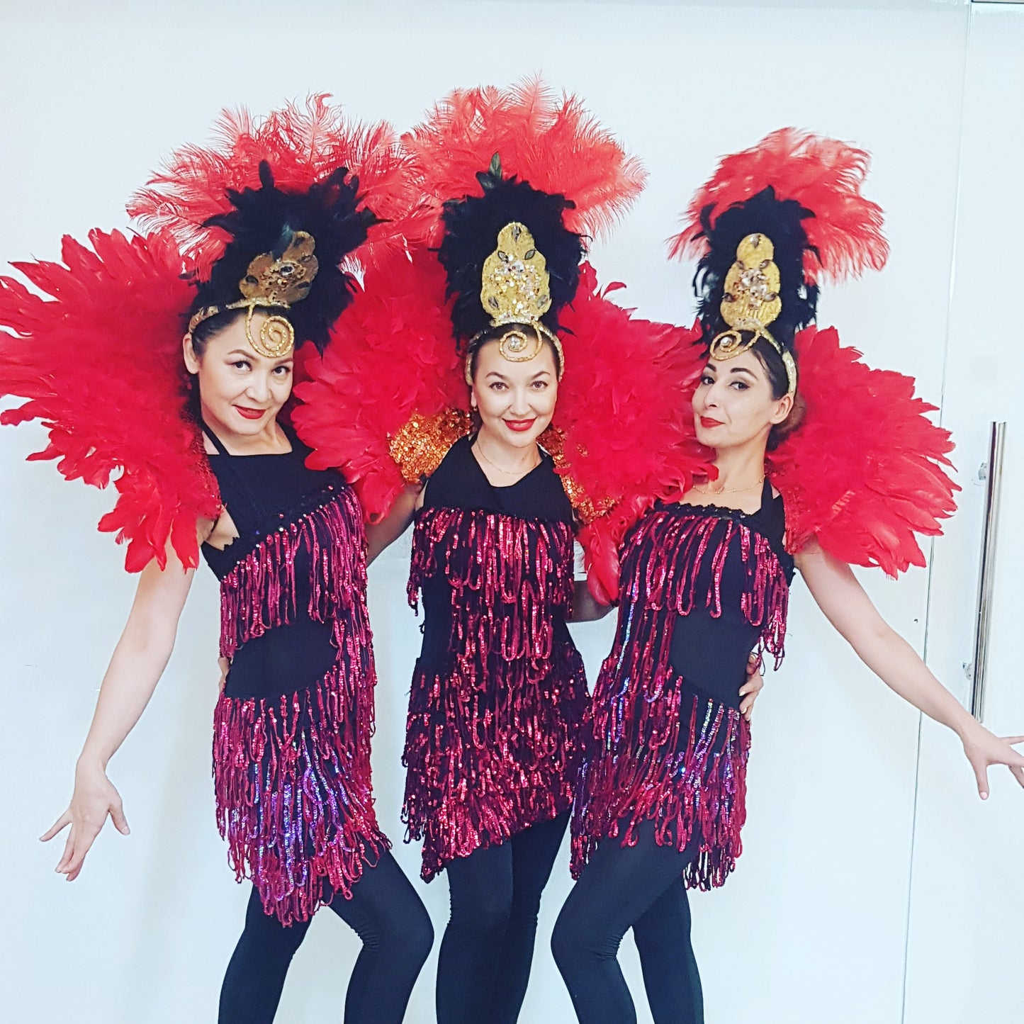 Red feather cabaret dancers by Fidelio Arts